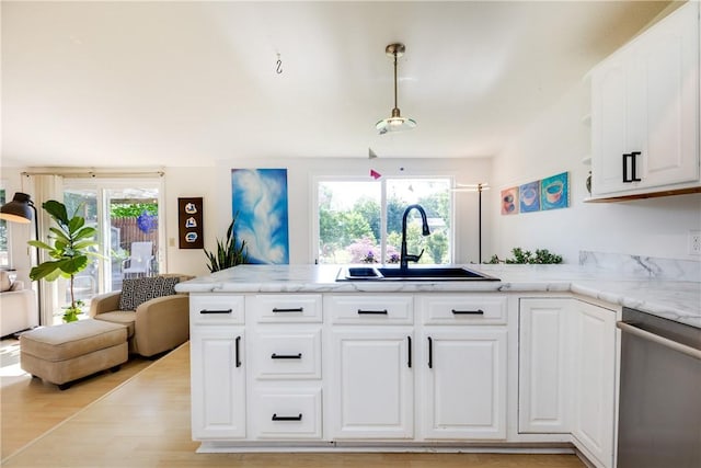 2804 Westinghouse Rd, Horseheads, NY 14845 - kitchen featuring stainless steel dishwasher, open floor plan, a peninsula, light wood finished floors, and white cabinetry