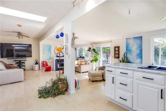 2804 Westinghouse Rd, Horseheads, NY 14845 - living room with light wood-type flooring, a skylight, and ceiling fan