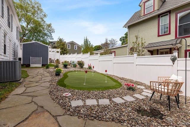 54 W 5th St, Oswego-City, NY 13126 - view of yard with an area to practice putting and central AC unit