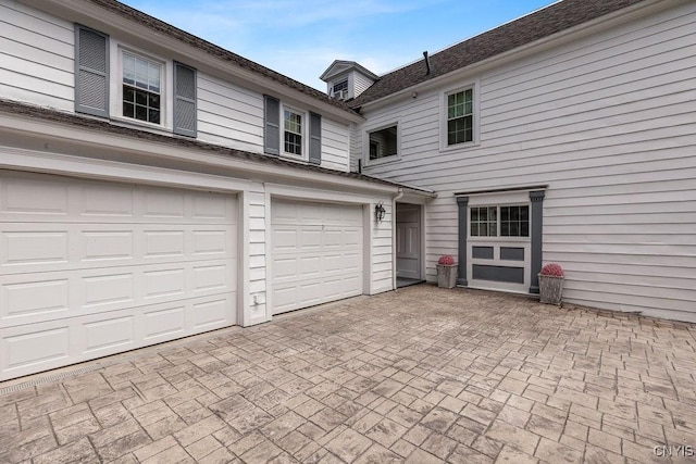 54 W 5th St, Oswego-City, NY 13126 - garage featuring decorative driveway