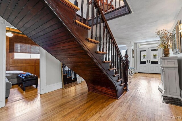 54 W 5th St, Oswego-City, NY 13126 - stairs with wood-type flooring and baseboards