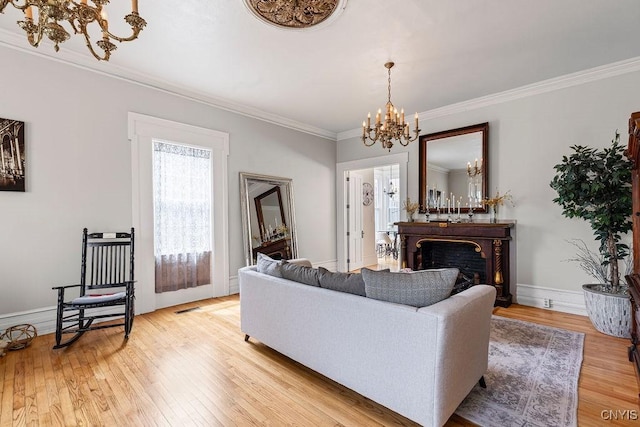 54 W 5th St, Oswego-City, NY 13126 - living area featuring a chandelier, crown molding, light wood-style flooring, a fireplace, and baseboards