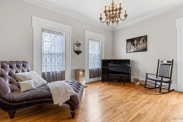 54 W 5th St, Oswego-City, NY 13126 - living area featuring light wood-style flooring, a chandelier, crown molding, and baseboards