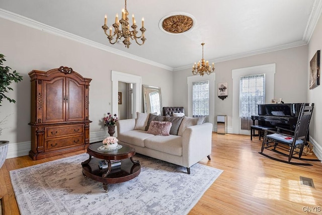 54 W 5th St, Oswego-City, NY 13126 - living room featuring a chandelier, light wood-style flooring, ornamental molding, and baseboards