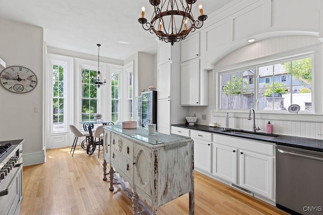 54 W 5th St, Oswego-City, NY 13126 - kitchen with dishwasher, a chandelier, a sink, light wood-style flooring, and white cabinetry