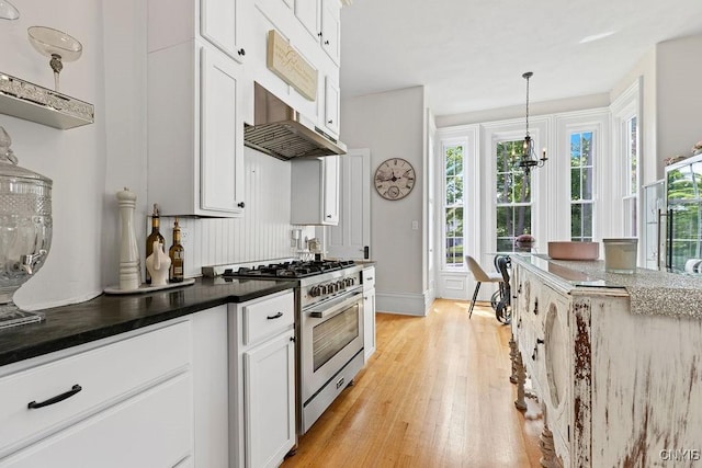 54 W 5th St, Oswego-City, NY 13126 - kitchen featuring high end stainless steel range, light wood-style floors, white cabinets, hanging light fixtures, and baseboards