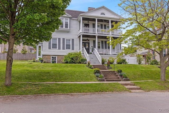 54 W 5th St, Oswego-City, NY 13126 - neoclassical home with stairway, a balcony, covered porch, and a chimney