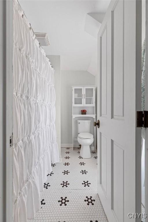 54 W 5th St, Oswego-City, NY 13126 - full bath featuring toilet, vaulted ceiling, tile patterned floors, and baseboards