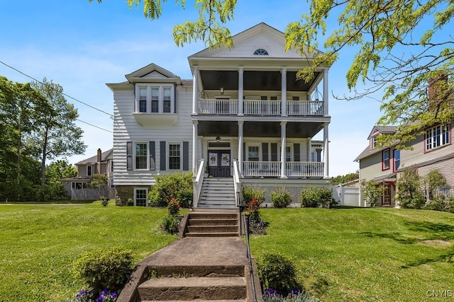 54 W 5th St, Oswego-City, NY 13126 - view of front facade featuring a porch, a front yard, a balcony, and stairway