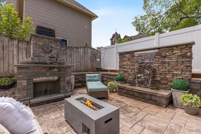 54 W 5th St, Oswego-City, NY 13126 - view of patio with an outdoor stone fireplace and an outdoor fire pit
