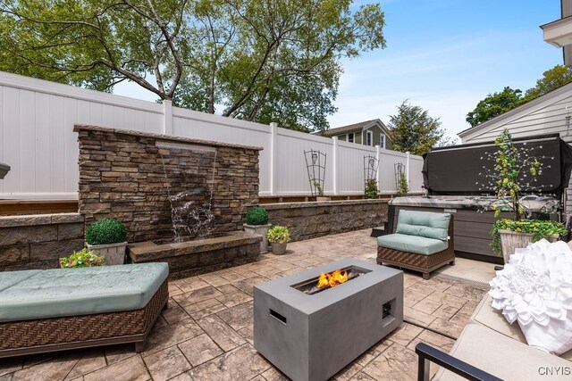 54 W 5th St, Oswego-City, NY 13126 - view of patio featuring an outdoor fire pit and a hot tub