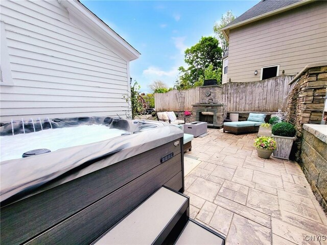 54 W 5th St, Oswego-City, NY 13126 - view of patio featuring an outdoor stone fireplace and a hot tub