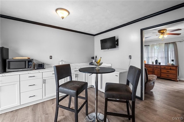 30 Bakeman St, Fulton, NY 13069 - dining room featuring crown molding, wood finished floors, and a ceiling fan