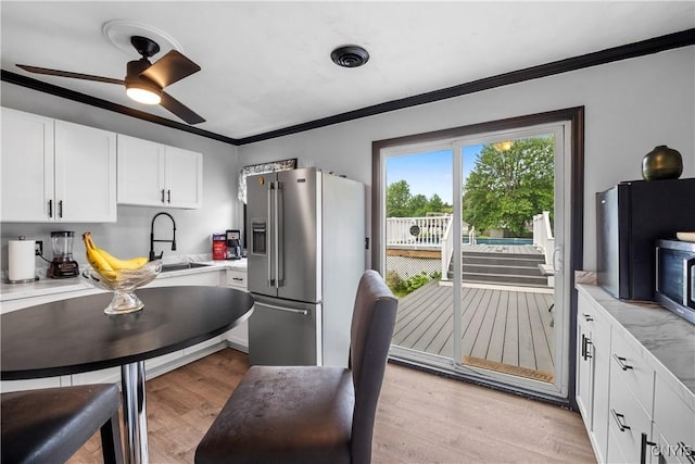 30 Bakeman St, Fulton, NY 13069 - kitchen featuring appliances with stainless steel finishes, a sink, crown molding, light countertops, and white cabinetry