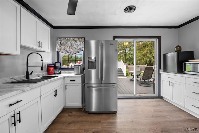 30 Bakeman St, Fulton, NY 13069 - kitchen with stainless steel appliances, a sink, crown molding, white cabinetry, and wood finished floors