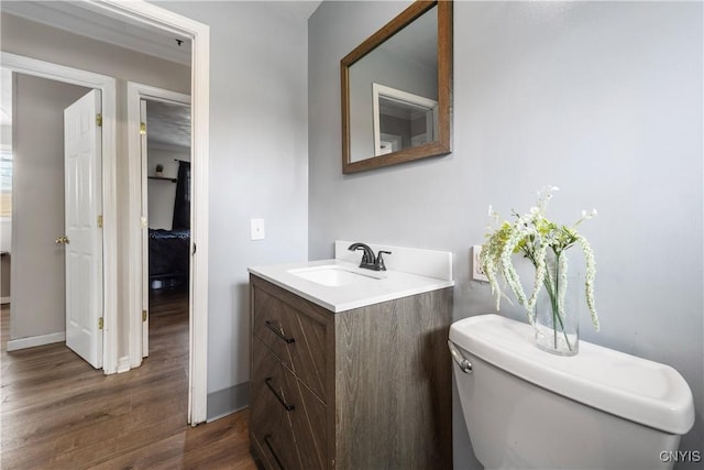 30 Bakeman St, Fulton, NY 13069 - half bathroom with vanity, wood finished floors, toilet, and baseboards