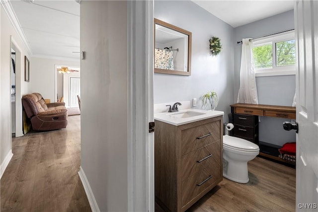 30 Bakeman St, Fulton, NY 13069 - full bath featuring vanity, wood finished floors, toilet, crown molding, and baseboards