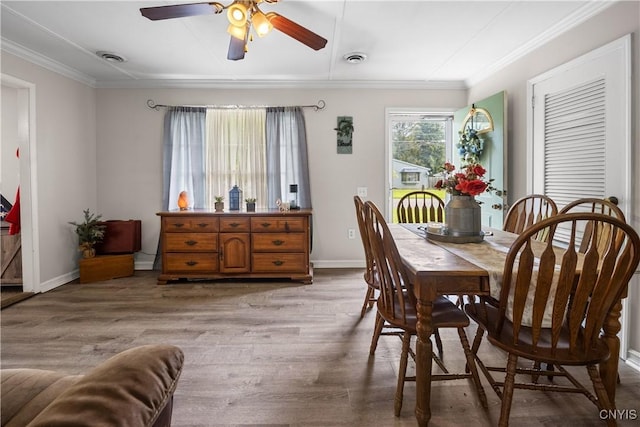 30 Bakeman St, Fulton, NY 13069 - dining area with crown molding, wood finished floors, ceiling fan, and baseboards