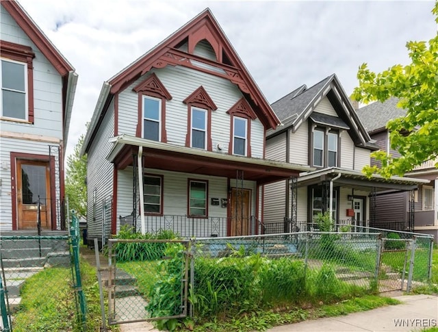 318 14th St, Buffalo, NY 14213 - victorian home featuring a porch, a gate, and a fenced front yard
