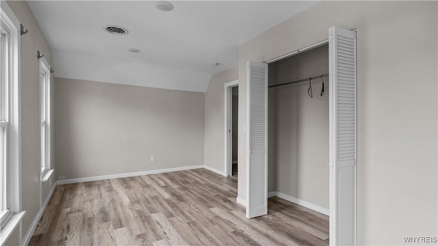 318 14th St, Buffalo, NY 14213 - unfurnished bedroom with wood finished floors, a closet, vaulted ceiling, and baseboards