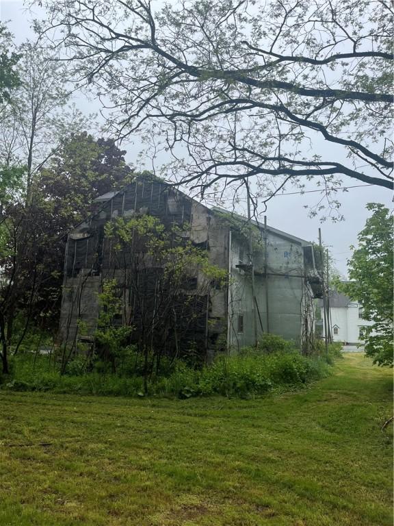 8193 State Highway 206, Tompkins, NY 13839 - view of side of property featuring a yard, an outbuilding, concrete block siding, and a barn