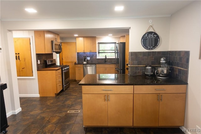 50 Cambria St, Lancaster, NY 14086 - kitchen with appliances with stainless steel finishes, a peninsula, backsplash, a sink, and baseboards