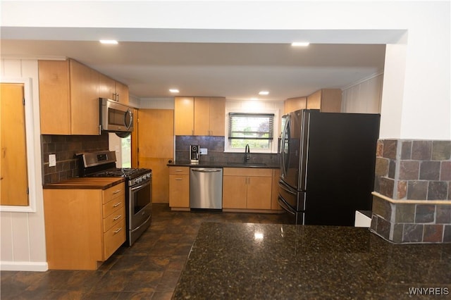 50 Cambria St, Lancaster, NY 14086 - kitchen with appliances with stainless steel finishes, a sink, decorative backsplash, dark stone counters, and light brown cabinets