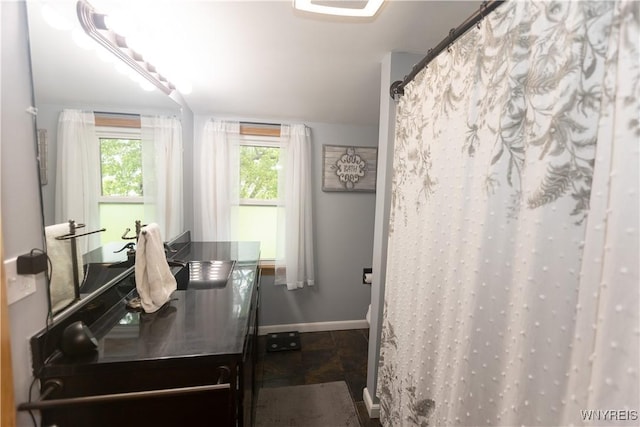 50 Cambria St, Lancaster, NY 14086 - full bathroom featuring vanity, baseboards, curtained shower, and stone finish floors