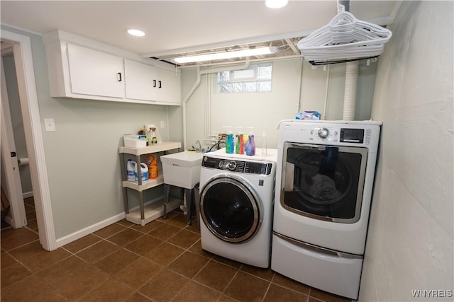 50 Cambria St, Lancaster, NY 14086 - washroom with washer and clothes dryer, cabinet space, recessed lighting, dark tile patterned flooring, and baseboards