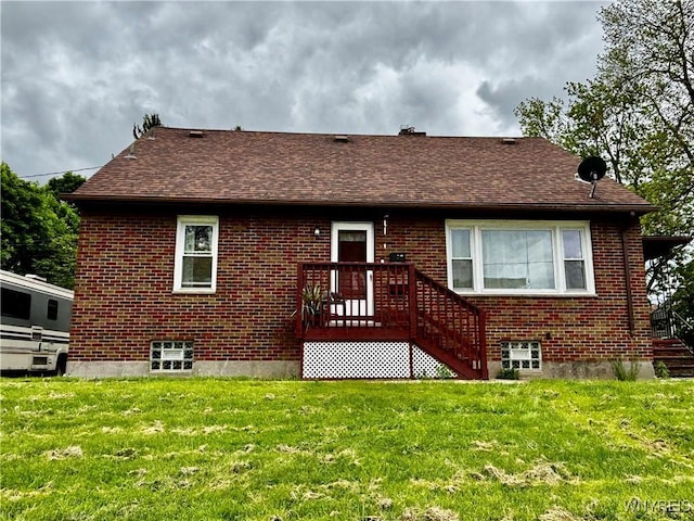 761 4th St, Niagara Falls, NY 14301 - back of property featuring brick siding, a lawn, and roof with shingles