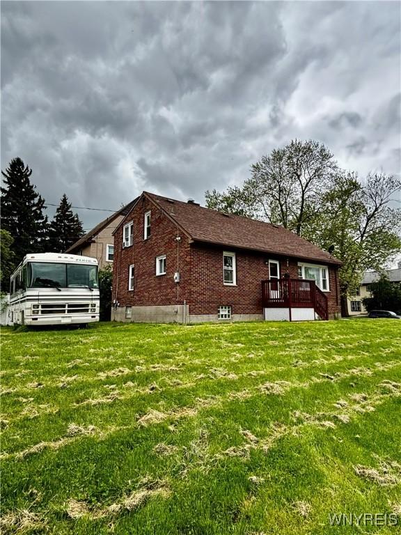 761 4th St, Niagara Falls, NY 14301 - view of side of property with brick siding and a yard