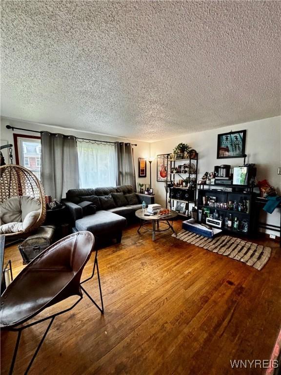 761 4th St, Niagara Falls, NY 14301 - living area with a textured ceiling and wood finished floors