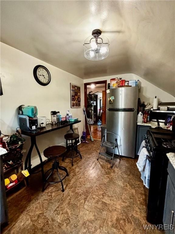 761 4th St, Niagara Falls, NY 14301 - kitchen featuring freestanding refrigerator, black gas range, and lofted ceiling