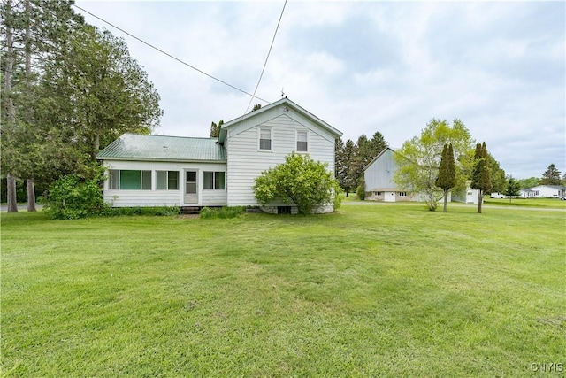 7709 Ridge Rd, Lowville, NY 13367 - rear view of house with a yard and metal roof