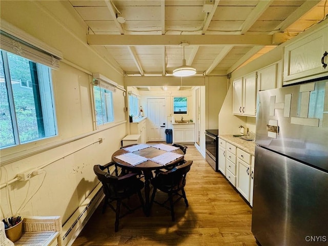 274 S Shore Rd, Webb, NY 13420 - dining area featuring a baseboard radiator, plenty of natural light, light wood-type flooring, and wood ceiling with exposed beams