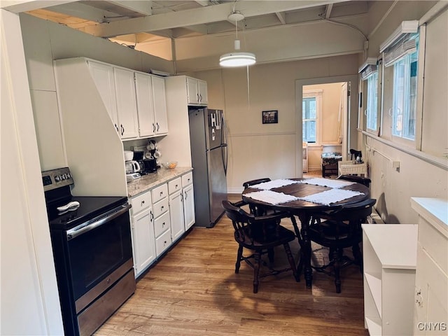 274 S Shore Rd, Webb, NY 13420 - kitchen featuring stainless steel appliances, white cabinets, light wood-style floors, beamed ceiling, and light stone countertops
