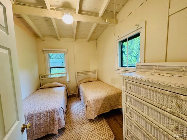274 S Shore Rd, Webb, NY 13420 - bedroom with beam ceiling, multiple windows, and dark wood-style floors