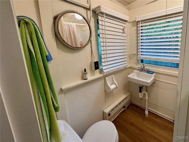 274 S Shore Rd, Webb, NY 13420 - bathroom featuring baseboard heating, wood finished floors, toilet, and a sink