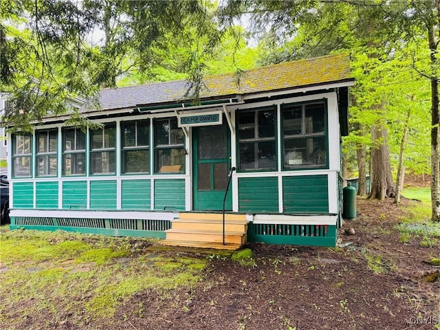 274 S Shore Rd, Webb, NY 13420 - view of front of home featuring a sunroom and entry steps
