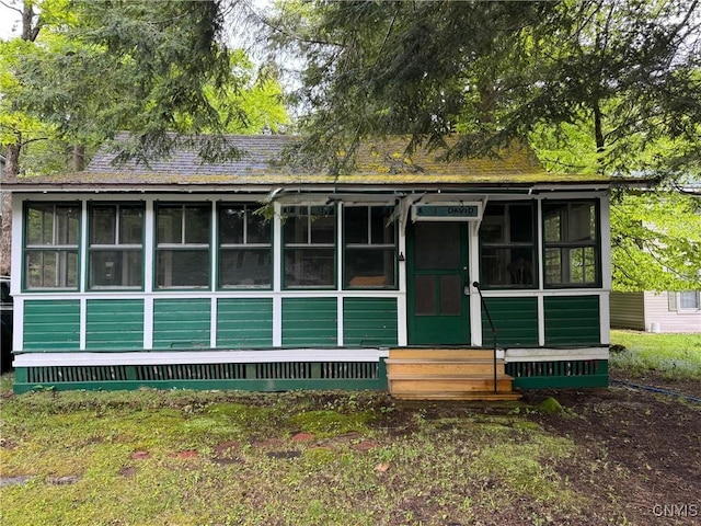 274 S Shore Rd, Webb, NY 13420 - view of front facade featuring a sunroom