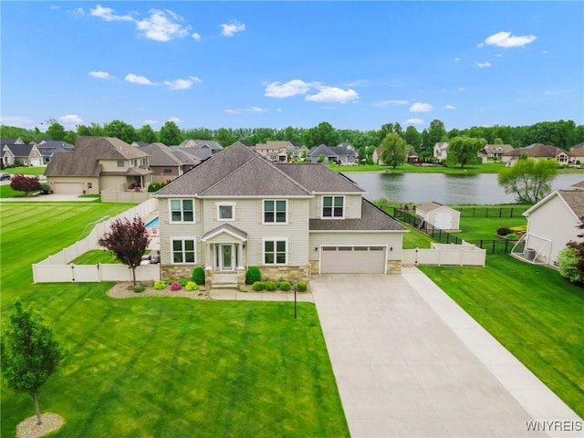 3906 Ontario Dr, Wheatfield, NY 14120 - view of front of property with stone siding, a residential view, a water view, concrete driveway, and a gate