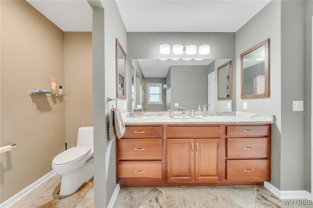 3906 Ontario Dr, Wheatfield, NY 14120 - bathroom featuring toilet, vanity, and baseboards