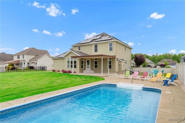 3906 Ontario Dr, Wheatfield, NY 14120 - rear view of house featuring roof mounted solar panels and a patio