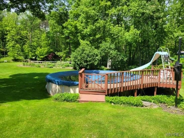4368 State Route 19, Gainesville, NY 14550 - view of pool with a lawn, a wooden deck, and a water slide