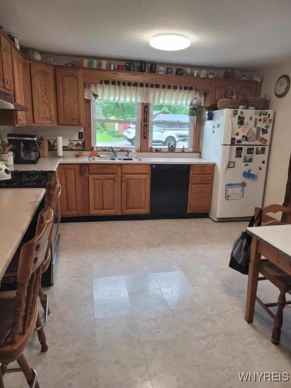 4368 State Route 19, Gainesville, NY 14550 - kitchen featuring dishwasher, freestanding refrigerator, a sink, exhaust hood, and light countertops