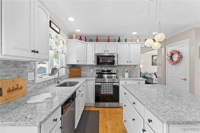1660 Shallow Creek Trl, Webster, NY 14580 - kitchen with appliances with stainless steel finishes, a sink, ornamental molding, white cabinets, and recessed lighting