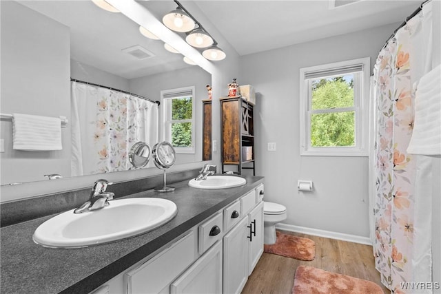 1660 Shallow Creek Trl, Webster, NY 14580 - bathroom with double vanity, wood finished floors, toilet, baseboards, and a shower with shower curtain