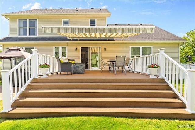 1660 Shallow Creek Trl, Webster, NY 14580 - rear view of house with a wooden deck and outdoor dining space