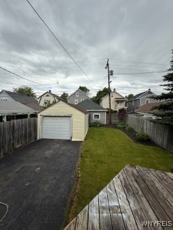 244 Parkwood Ave, Tonawanda-Town, NY 14217 - view of yard featuring an outdoor structure, driveway, a detached garage, a deck, and a residential view