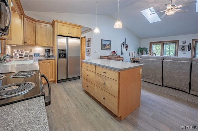 8654 Rochester Rd, Royalton, NY 14067 - kitchen featuring appliances with stainless steel finishes, light brown cabinetry, a sink, vaulted ceiling, and a skylight